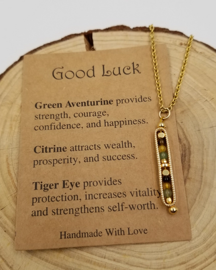 Gold necklace with inspirational card detailing gemstones Green Aventurine Citrine and Tiger Eye benefits