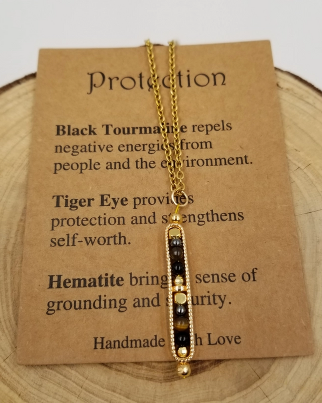 Chakra Jewelry gold necklace with black tourmaline, tiger eye, and hematite beads on necklace with inspirational card